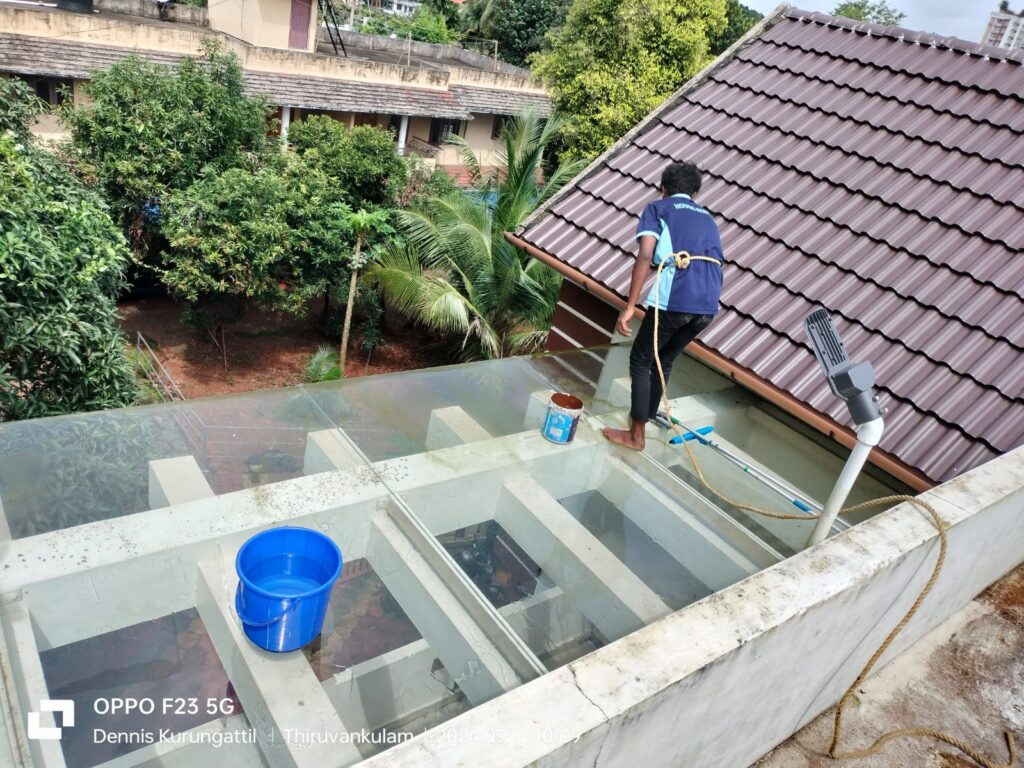 Pressure washing a glass roof canopy at a home in Ernakulam
